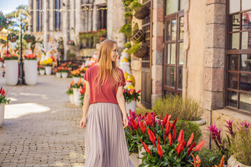 Young woman tourist walks down the street in a European city after the end of COVID-19 coronavirus....