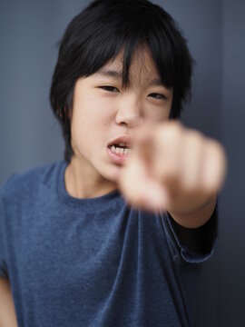 Funny Portrait Of 11 Years Old Asian Boy With Dark Blue T Shirt	