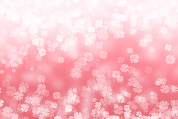 Abstract bokeh background with four leaf clover pattern in pink colour