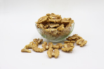 Bowl with tasty walnuts isolated on white background