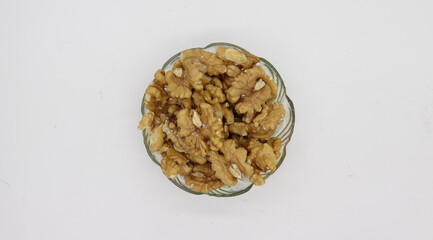 Bowl with tasty walnuts isolated on white background