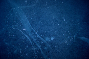 backround from air bubbles and cracks in the ice dark blue and blue colors