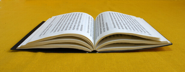 An open book with pages on which the text is arranged in an unusual way.