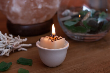 January 2021: Vintage tea light setup, candle surrounded by a salt lamp, sea glass and coral. 