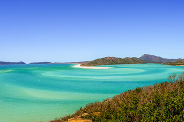 Panorama of iconic and amazingly beautiful Whitehaven Beach in the Whitsunday Coast, Queensland taken in summer time on a beautiful blue sky day. 