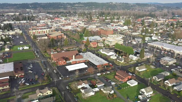 Cinematic aerial drone dolly footage of the residential and commercial downtown area of Puyallup in Pierce County, Washington