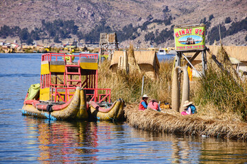 Fototapeta na wymiar Traditional reed boat of the Uros islands, Lake Titicaca, Puno, Peru