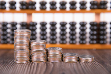 Chinese abacus and a row of dollar coins