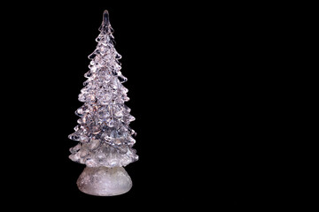 Transparent glass figurine of a New Year tree.