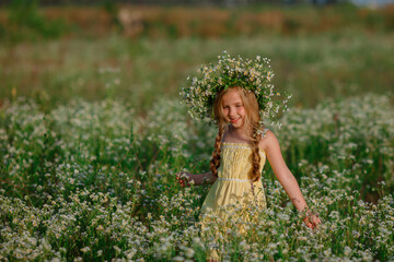 little girl in the field with a wreath on her head walking summer
