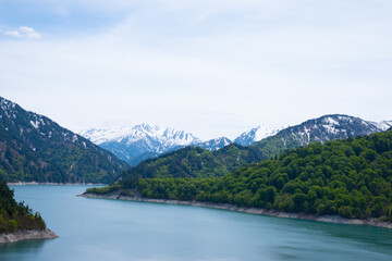 Beautiful lake, ferry and mountain in Kurobe dam, Toyama, Japan