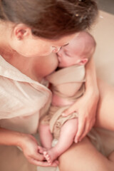 Mother holding newborn baby and breastfeedidiing little infant kid in hands
