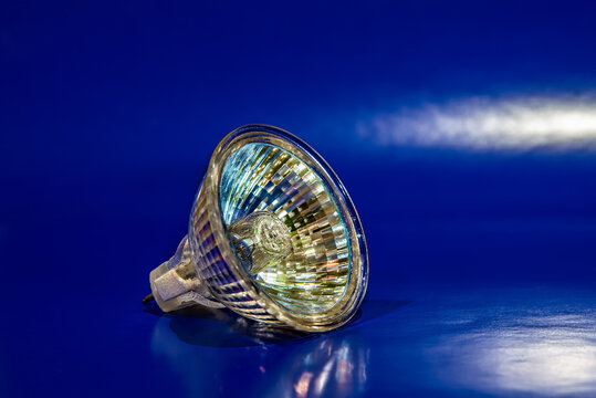 Halogen lamp with reflector on blue background