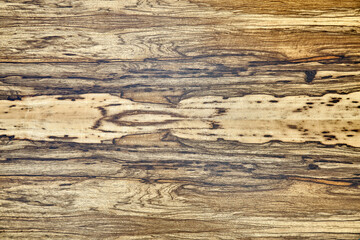 Obraz na płótnie Canvas Texture of elegant contemporary Black Ofram natural veneer with abstract beige and brown patterns as background extreme closeup