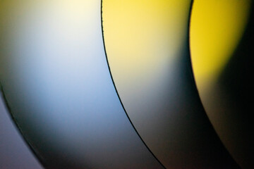 Background macro image pattern made of folded curved sheets of paper with multi color light illuminate  