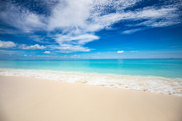 Closeup of sand on beach and blue summer sky. Panoramic beach landscape. Empty tropical beach and seascape. Blue sky, soft sand, calmness, tranquil relaxing sunlight, summer mood. Travel vacation