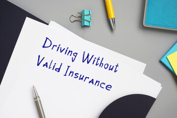 Legal concept about Driving Without Valid Insurance with inscription on the piece of paper.