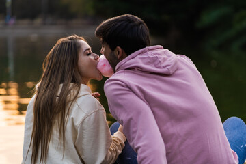 Fototapeta premium Happy couple eating cotton candy, lifestyle