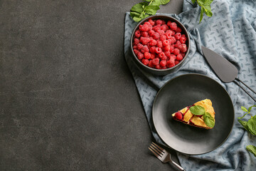 Piece of tasty raspberry pie on dark background