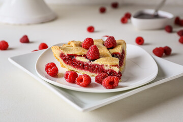 Piece of delicious raspberry pie on light background, closeup