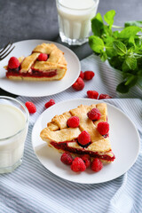 Pieces of delicious raspberry pie on table