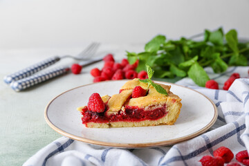 Piece of delicious raspberry pie on table