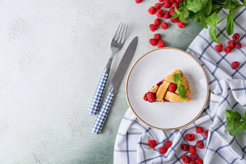 Piece of delicious raspberry pie on table