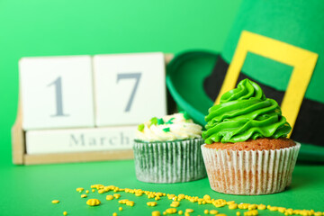 Tasty cupcakes for St. Patrick's Day on color background