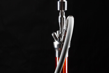 Close up of modern hookah on black background