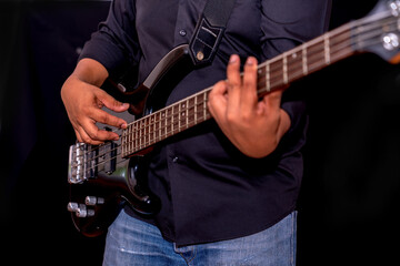 Fototapeta na wymiar A man playing bass guitar on rock music.
