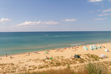 Fototapeta na wymiar view of the beach on the black sea coast. Summer vacationers at the sea.