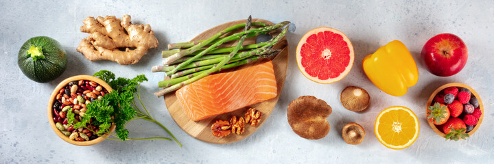 Healthy food panorama. Salmon, grapefruit and asparagus, ginger etc, overhead flat lay shot