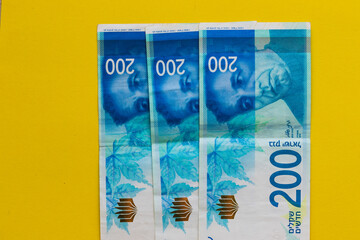 New Israeli banknotes of two hundred shekels, yellow background