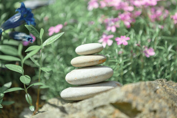 Obraz na płótnie Canvas balancing pile of pebble stones, like ZEN stone, outdoor in springtime, spa wellness tranquil scene concept, soul equanimity mental calmness picture