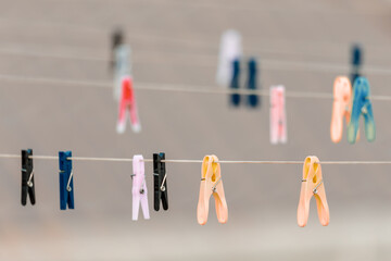 various colors of Clothes pegs on the washing line