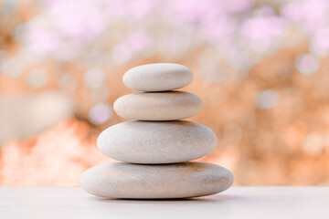 Obraz na płótnie Canvas balancing pile of pebble stones, like ZEN stone, outdoor in springtime, spa wellness tranquil scene concept, soul equanimity mental calmness picture