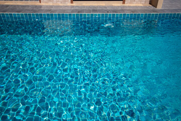 Fototapeta na wymiar Wave of blue swimming pool background