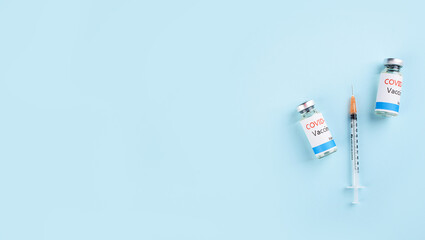 Covid-19 Corona Virus 2019-ncov vaccine vials medicine drug bottles syringe injection. Vaccination, immunization, treatment to cure Covid 19 Corona Virus infection.