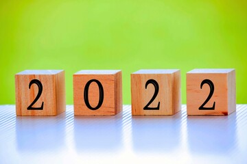 2022 number on wooden block with green background