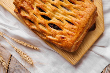 Top view on fresh baked berry jam pie on the wooden cutting board