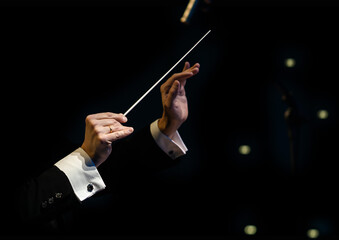  Hands of the conductor of a symphony orchestra closeup
