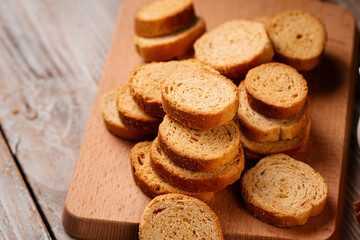 Closeup on pile of dried bread crackers on the wooden background