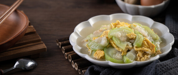 Taiwanese homemade local food of scrambled eggs with loofah gourd and sesame oil.
