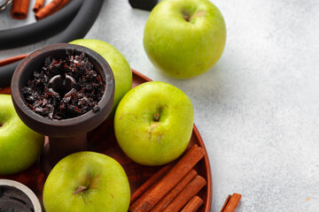 Hookah parts with green apples on table