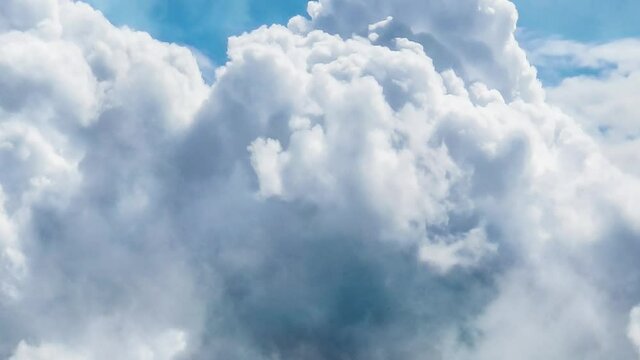 zoom in, thick cumulonimbus clouds in the clear blue sky.