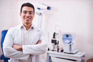 Smiling amicable ophthalmologist waiting for his patients