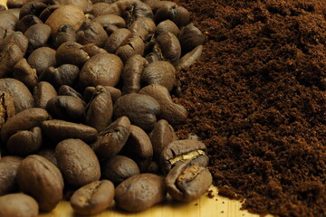 The background of coffee beans and ground coffee. Macro. Brown