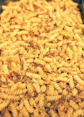 boiled pasta with meat and toppings in a metal pan, cooking