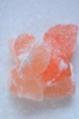 Pink himalayan salt  close-up on a light marble background.Pink crystal salt