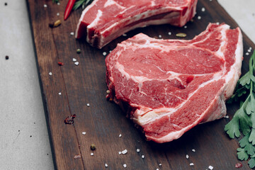 Raw beef meat fillet on wooden board